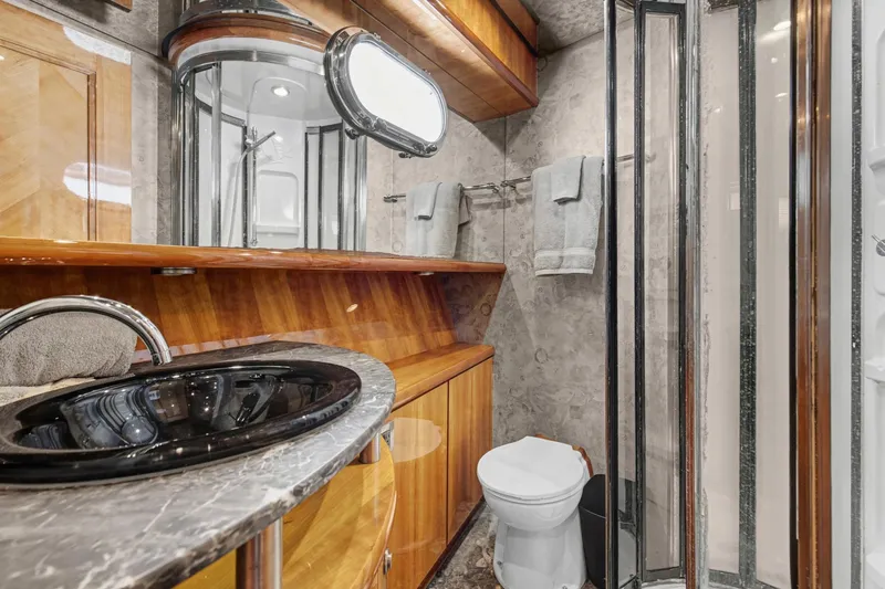 Slide: The Image of Luxurious bathroom in 2004 Queenship 76 Baretta yacht with elegant fixtures and wood accents. - 7