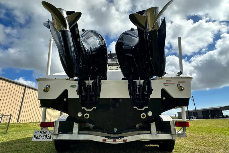 Slide: The Image of 2021 Sportsman Open 282 Center Console boat with dual outboard motors on trailer. - 10