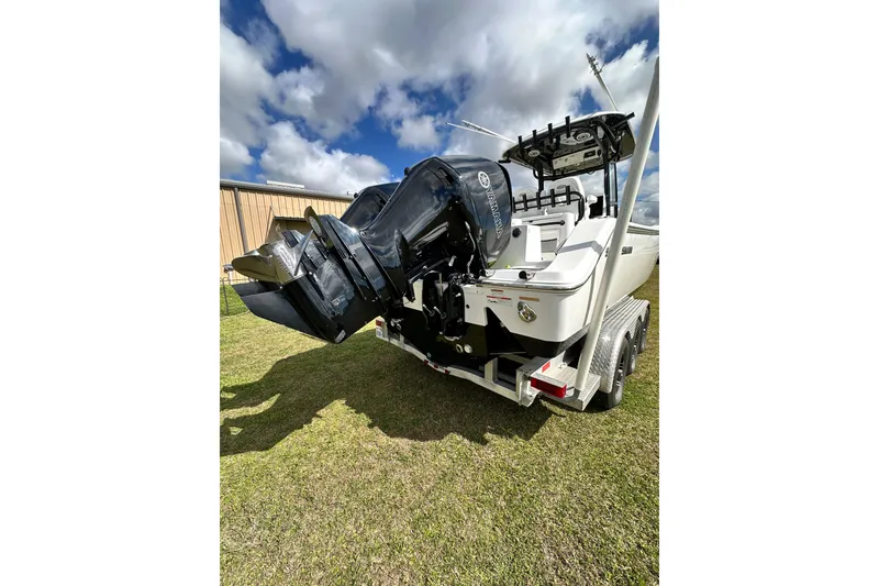 Slide: The Image of 2021 Sportsman Open 282 Center Console boat with dual Yamaha outboard engines on a trailer. - 11
