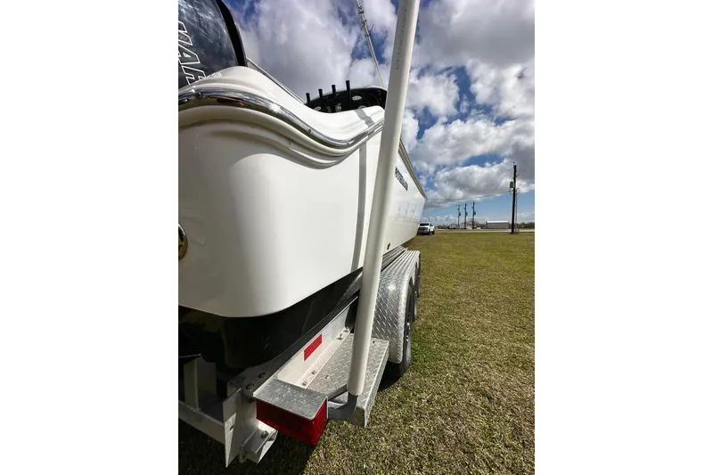 Slide: The Image of 2021 Sportsman Open 282 Center Console boat on trailer under cloudy sky. - 12