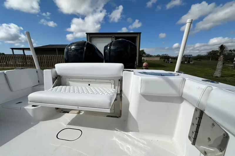 Slide: The Image of 2021 Sportsman Open 282 Center Console boat with dual engines and cushioned seating. - 19