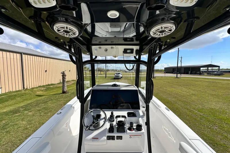 Slide: The Image of 2021 Sportsman Open 282 Center Console boat interior with steering and controls. - 22