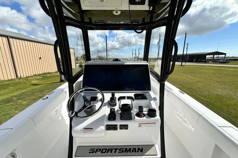 Slide: The Image of 2021 Sportsman Open 282 Center Console boat interior with steering wheel and controls. - 23