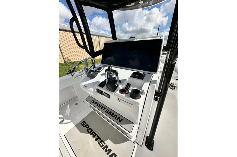 Slide: The Image of 2021 Sportsman Open 282 Center Console boat dashboard with steering wheel and controls. - 24