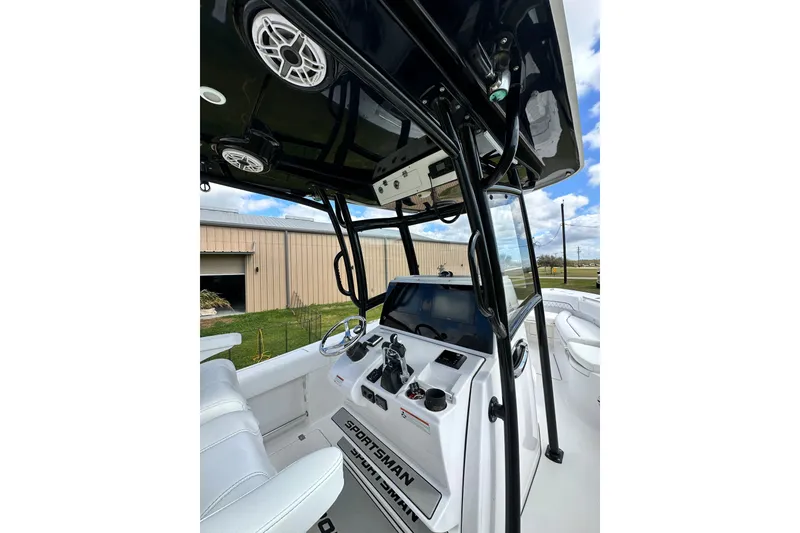 Slide: The Image of 2021 Sportsman Open 282 Center Console boat interior with steering and controls. - 25