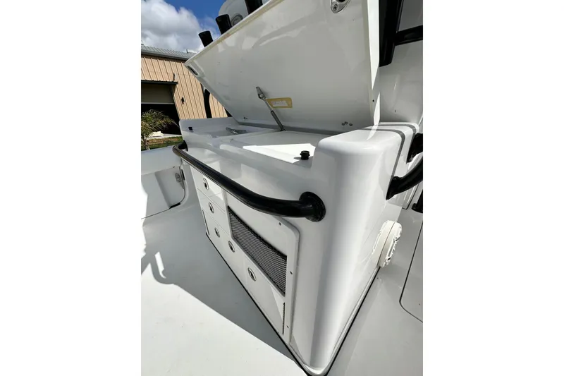 Slide: The Image of 2021 Sportsman Open 282 Center Console boat interior with storage compartment open. - 27
