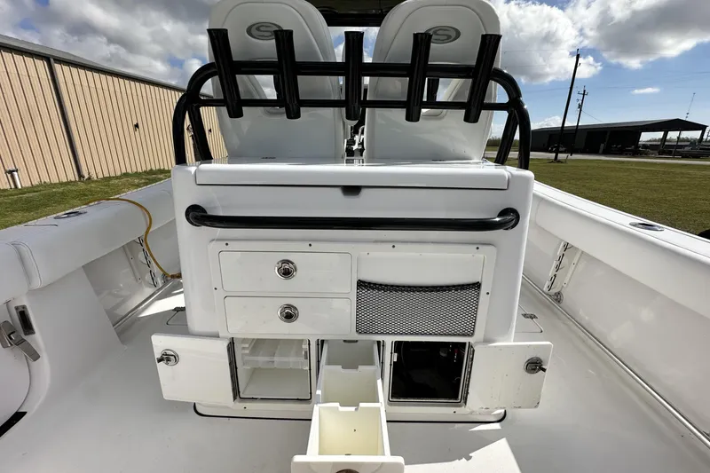 Slide: The Image of 2021 Sportsman Open 282 Center Console boat interior with storage compartments and seating. - 29