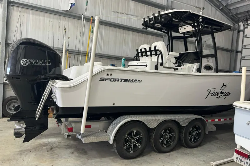 Slide: The Image of 2021 Sportsman Open 282 Center Console boat with Yamaha engine in a garage. - 3