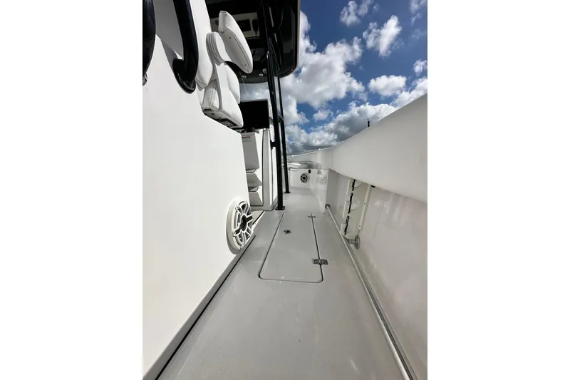 Slide: The Image of 2021 Sportsman Open 282 Center Console boat deck under a partly cloudy sky. - 31