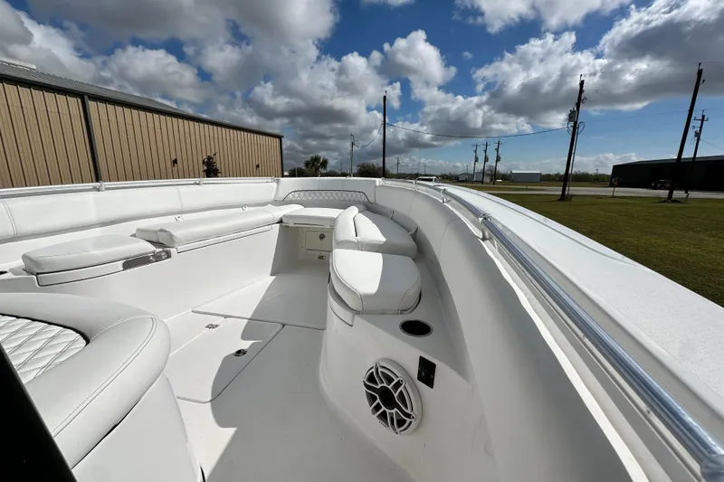 Slide: The Image of 2021 Sportsman Open 282 Center Console boat interior with white seating under a cloudy sky. - 36