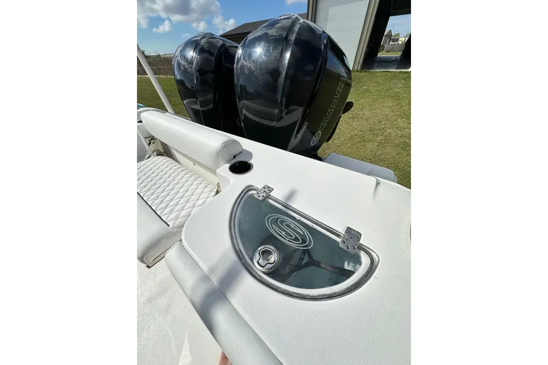 Slide: The Image of 2021 Sportsman Open 282 Center Console boat with dual Yamaha engines and cushioned seating. - 38