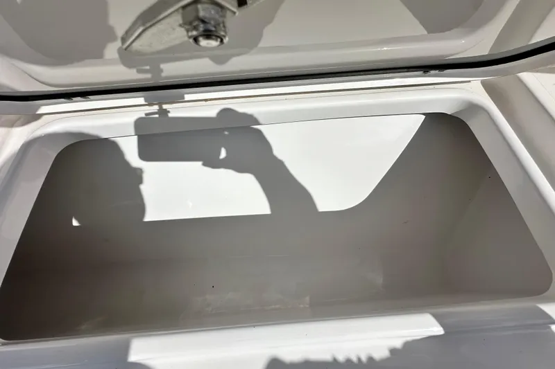Slide: The Image of Open storage compartment on a 2021 Sportsman Open 282 Center Console boat. - 44