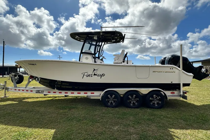 Slide: The Image of 2021 Sportsman Open 282 Center Console boat on trailer under cloudy sky. - 5