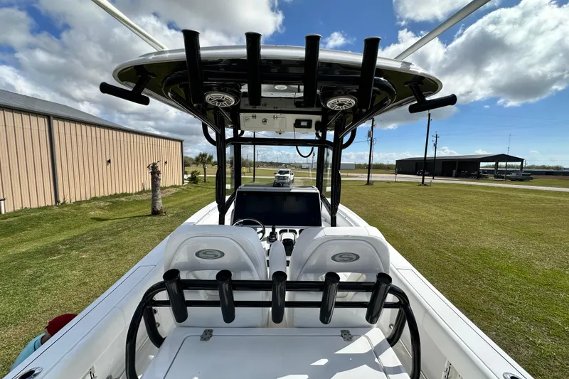 Slide: The Image of 2021 Sportsman Open 282 Center Console boat with T-top and seating, parked outdoors. - 53