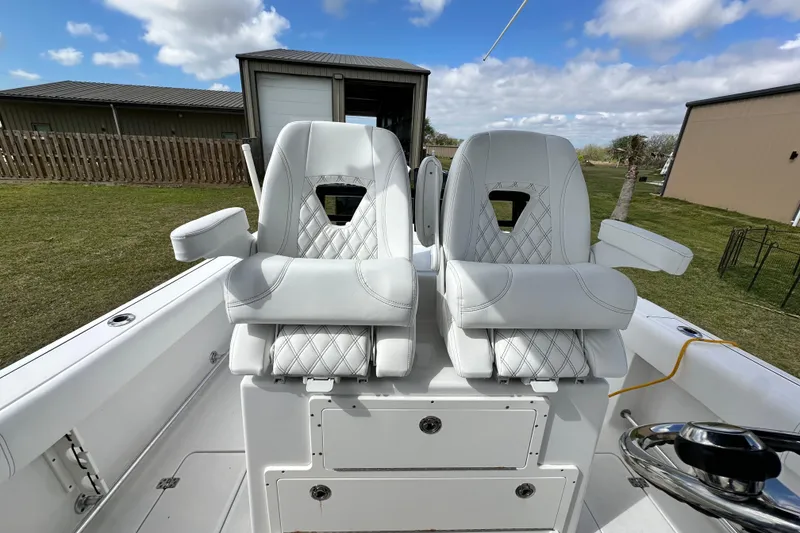Slide: The Image of 2021 Sportsman Open 282 Center Console with luxurious white seating and storage compartments. - 56
