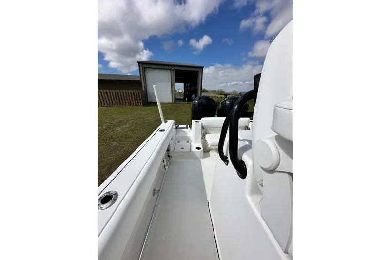 Slide: The Image of 2021 Sportsman Open 282 Center Console boat, docked outdoors under a partly cloudy sky. - 57