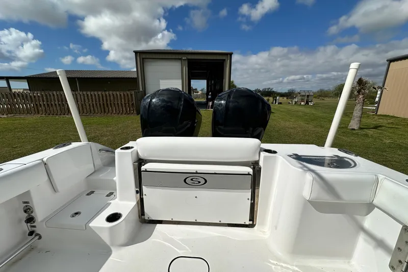 Slide: The Image of 2021 Sportsman Open 282 Center Console boat with dual engines, parked outdoors. - 59