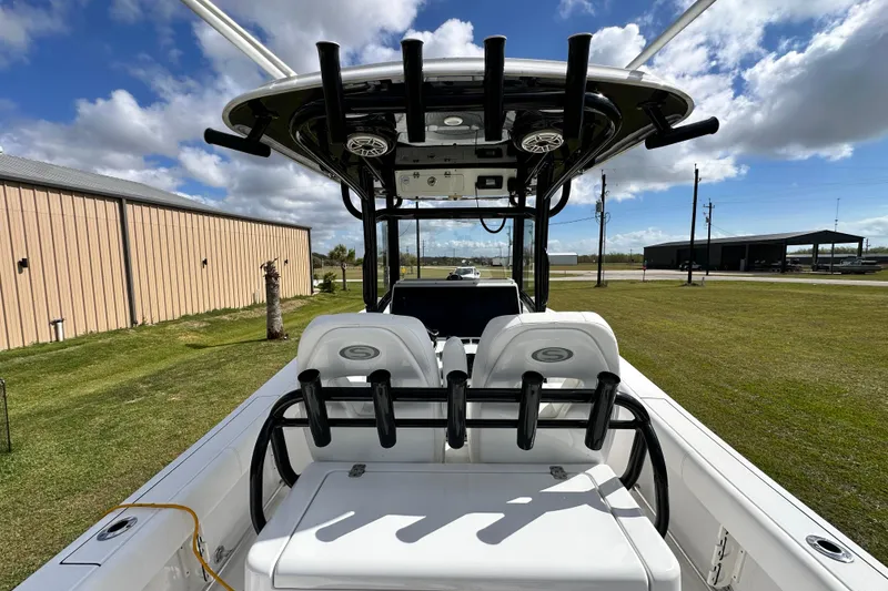 Slide: The Image of 2021 Sportsman Open 282 Center Console boat interior with seating and rod holders. - 60