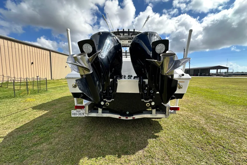 Slide: The Image of 2021 Sportsman Open 282 Center Console boat with dual outboard motors on a trailer. - 9