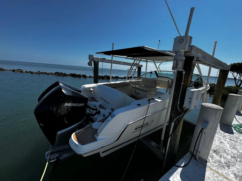 Slide: The Image of 2019 Boston Whaler 270 Vantage boat docked with Mercury engine, sunny day. - 10
