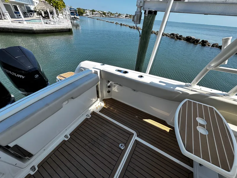 Slide: The Image of 2019 Boston Whaler 270 Vantage boat interior with wooden deck and seating area. - 18
