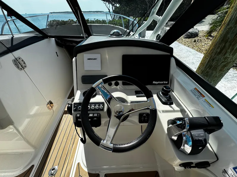 Slide: The Image of 2019 Boston Whaler 270 Vantage helm with steering wheel and controls. - 25