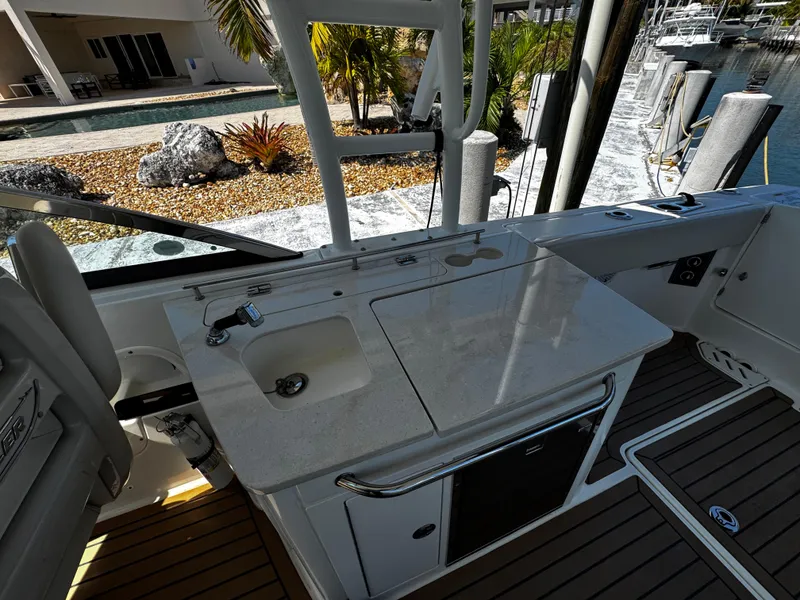 Slide: The Image of 2019 Boston Whaler 270 Vantage boat interior with sink and countertop near marina. - 33