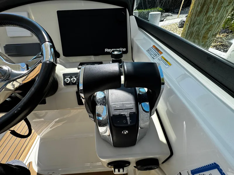 Slide: The Image of Control panel of 2019 Boston Whaler 270 Vantage with Raymarine display and steering wheel. - 36