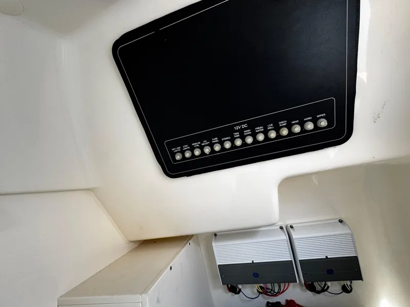 Slide: The Image of Interior view of 2019 Boston Whaler 270 Vantage boat's control panel and electrical components. - 39
