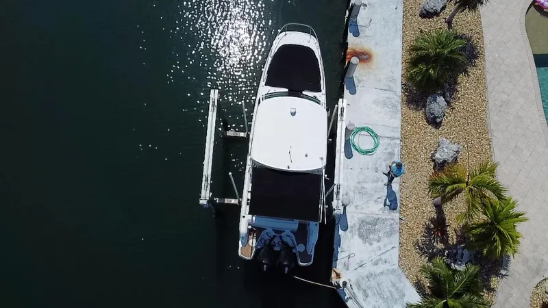 Slide: The Image of Aerial view of 2019 Boston Whaler 270 Vantage docked by a landscaped shoreline. - 5