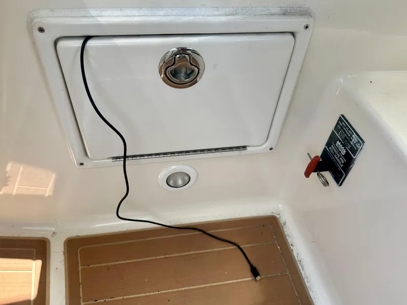 Slide: The Image of 2012 Sea Ray 310 Sundancer boat compartment with cable and control panel. - 30