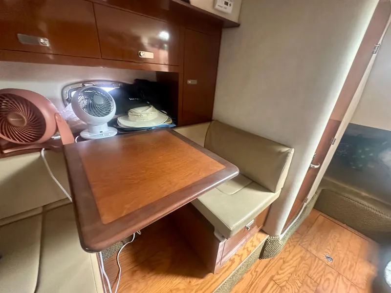 Slide: The Image of Interior of 2012 Sea Ray 310 Sundancer with seating, table, and fans. - 36