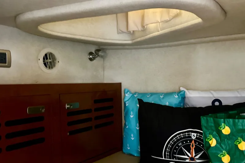Slide: The Image of Cozy cabin interior of 2012 Sea Ray 310 Sundancer with nautical-themed pillows. - 46