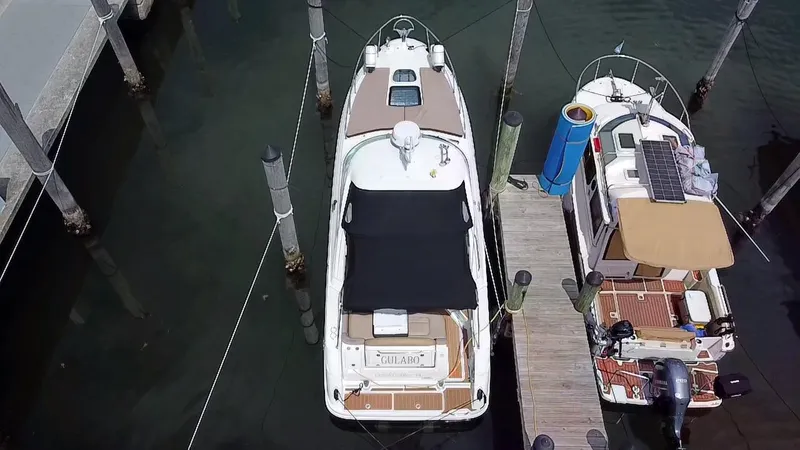 Slide: The Image of 2012 Sea Ray 310 Sundancer docked at marina, aerial view. - 9