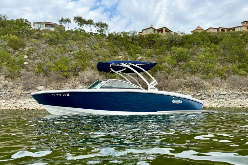 The Image of 2016 Cobalt CS3 boat on water, scenic background with trees and houses. - 1