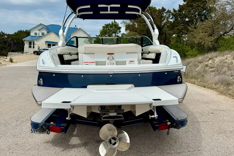 Slide: The Image of 2016 Cobalt CS3 boat on trailer, rear view, parked on a residential street. - 14