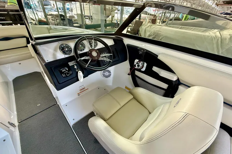 Slide: The Image of Interior of a 2016 Cobalt CS3 boat featuring steering wheel and beige seating. - 22