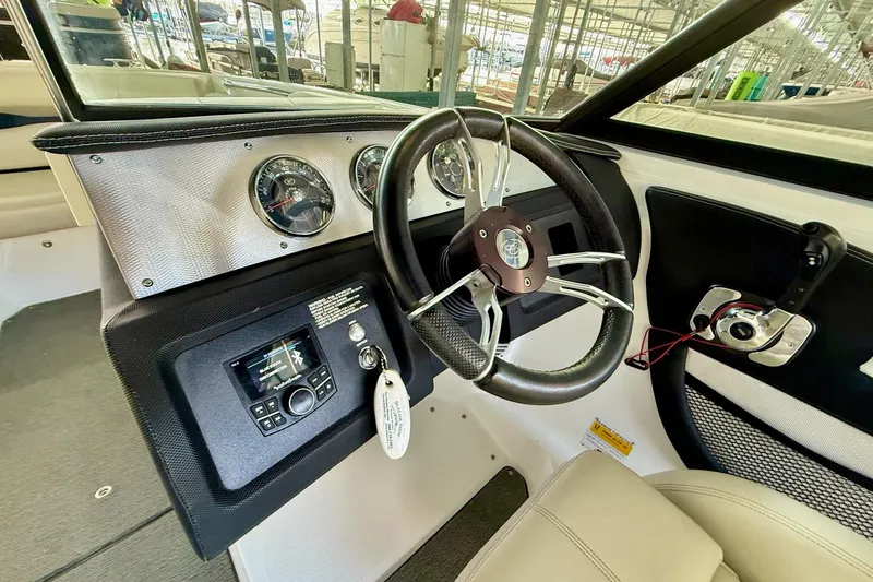 Slide: The Image of 2016 Cobalt CS3 boat dashboard with steering wheel and control panel. - 23