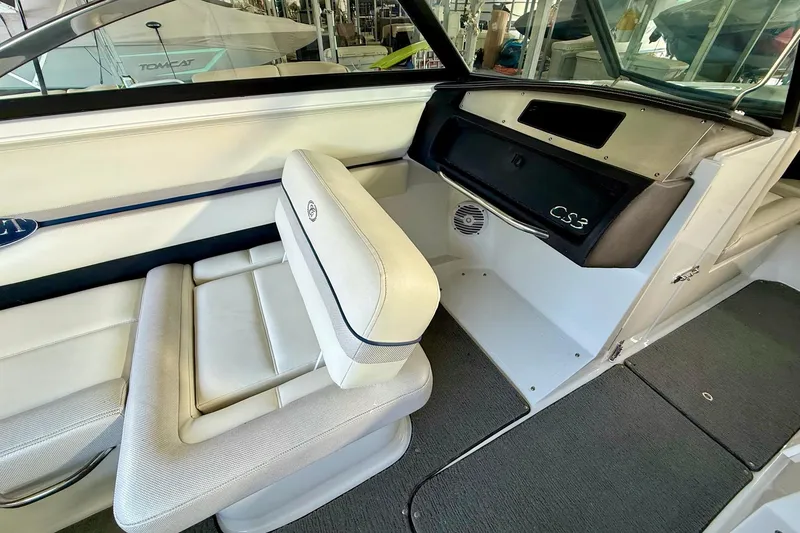 Slide: The Image of Interior of a 2016 Cobalt CS3 boat, featuring white seating and dashboard. - 24