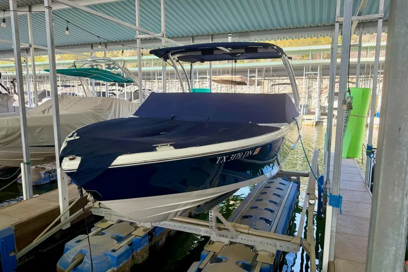Slide: The Image of 2016 Cobalt CS3 boat docked with cover in marina. - 29