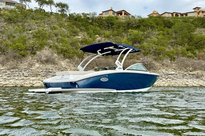 Slide: The Image of 2016 Cobalt CS3 boat on water, with scenic hillside background. - 5
