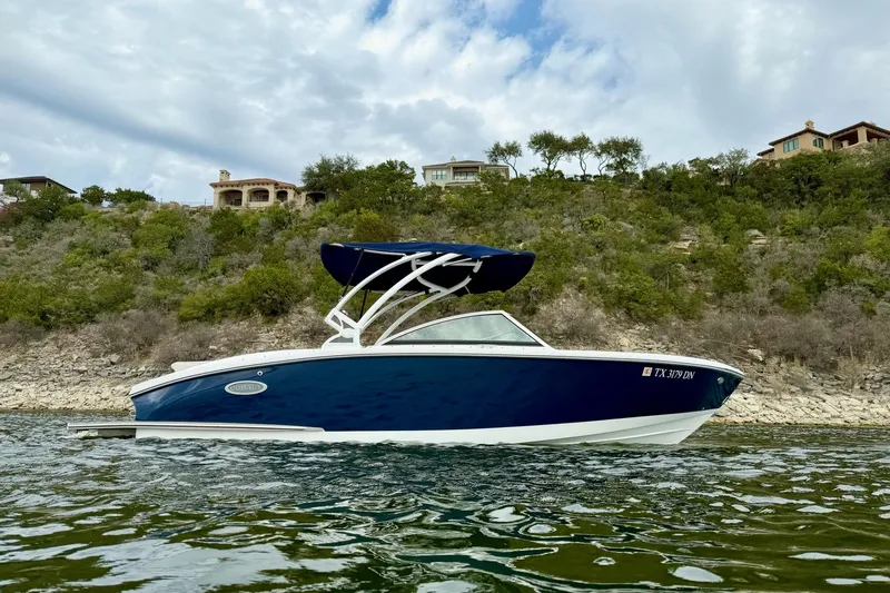 Slide: The Image of 2016 Cobalt CS3 boat on a lake with hillside background. - 6
