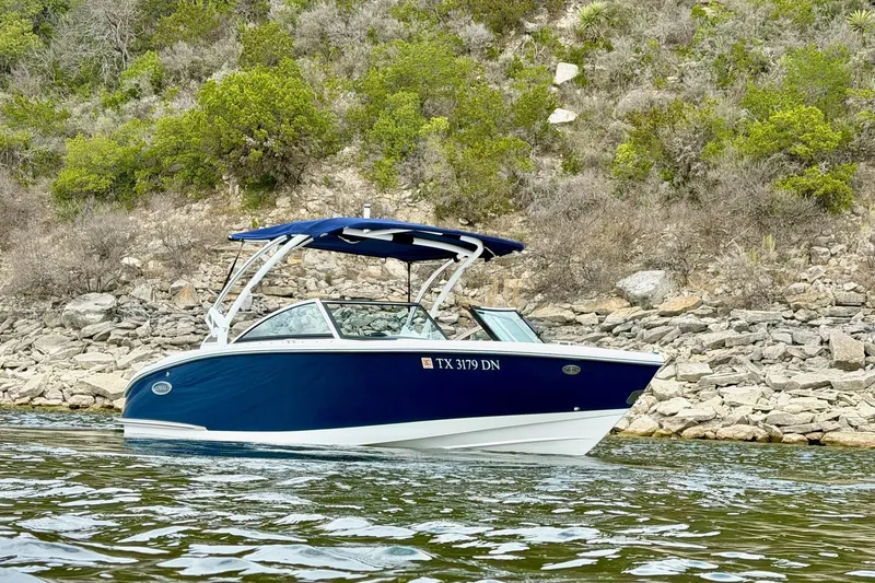 Slide: The Image of 2016 Cobalt CS3 boat on water near rocky shoreline. - 7