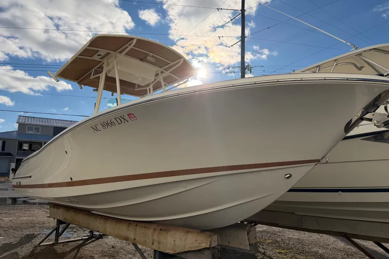 Slide: The Image of 2013 Chris-Craft Catalina 23 boat on display under a sunny sky. - 13