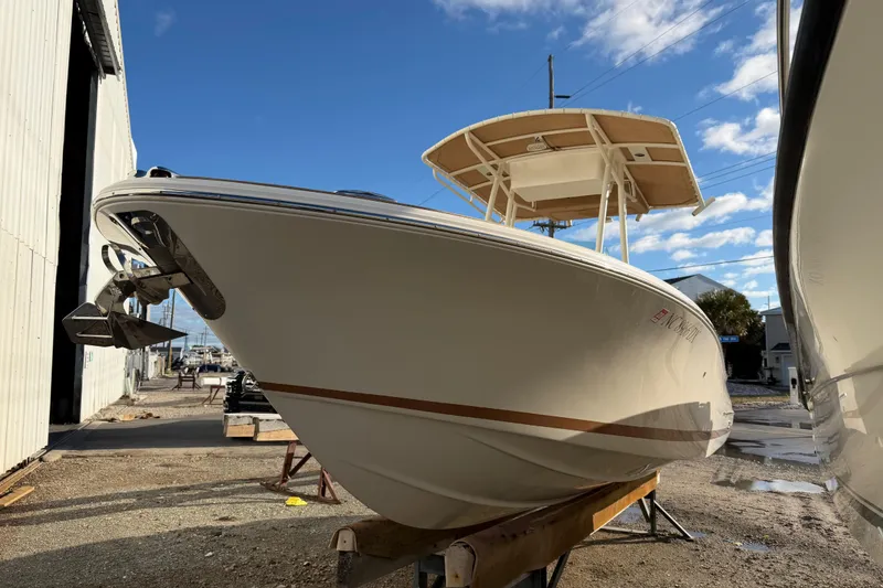 Slide: The Image of 2013 Chris-Craft Catalina 23 boat on display outdoors under a blue sky. - 14