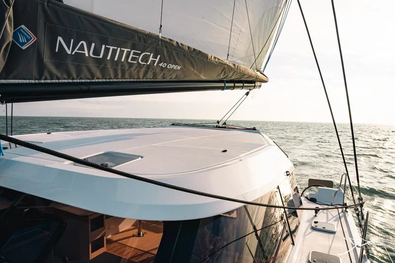 Slide: The Image of 2025 Nautitech 40 Open sailing on the ocean, showcasing sleek design and modern features. - 11
