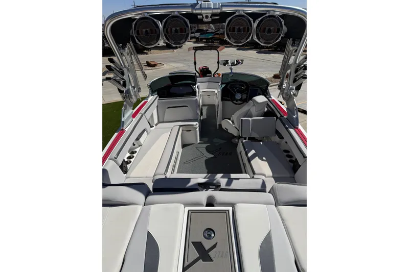 Slide: The Image of 2021 MasterCraft XStar boat interior with premium seating and sound system. - 11