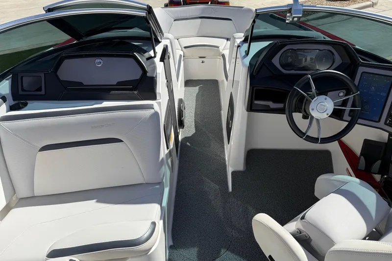 Slide: The Image of Interior of a 2021 MasterCraft XStar boat with modern dashboard and seating. - 13