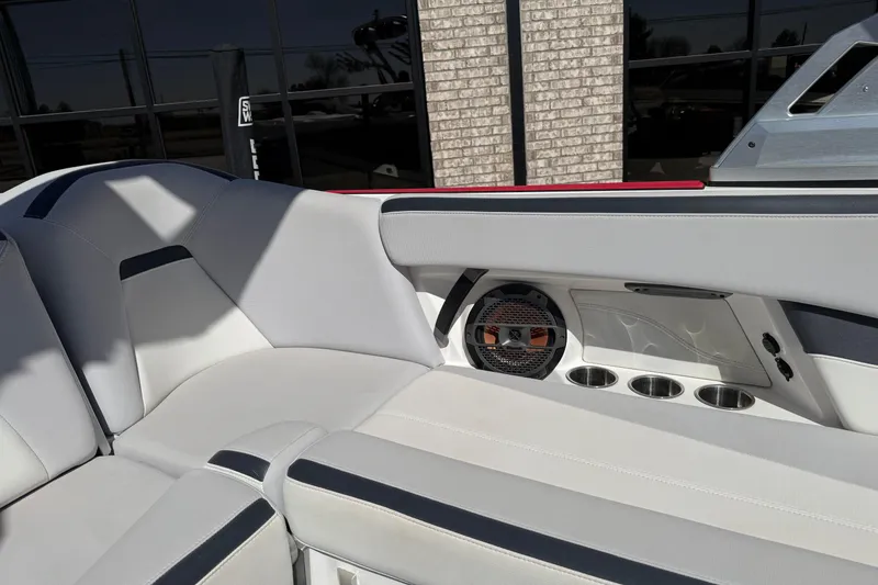 Slide: The Image of 2021 MasterCraft XStar interior with sleek seating, speaker, and cup holders. - 15