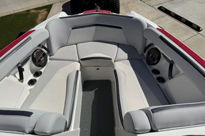 Slide: The Image of 2021 MasterCraft XStar boat interior with plush seating and cup holders. - 19